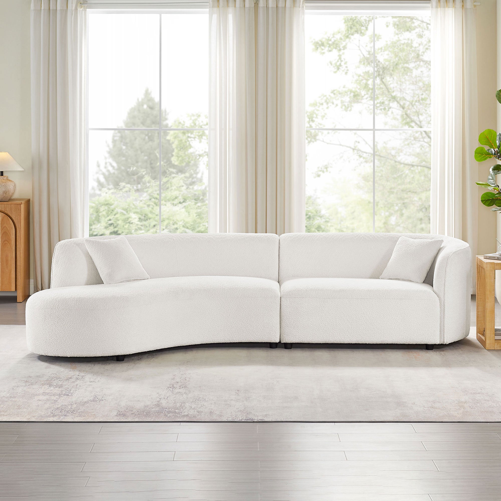 Front view of modern white bouclé curved sofa set with plush cushions, enhancing living room aesthetics with comfort and elegance.