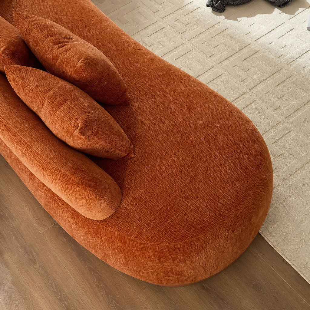 Curved armrest and seat detail of the orange oversized sectional sofa, emphasizing modern design and cozy seating.