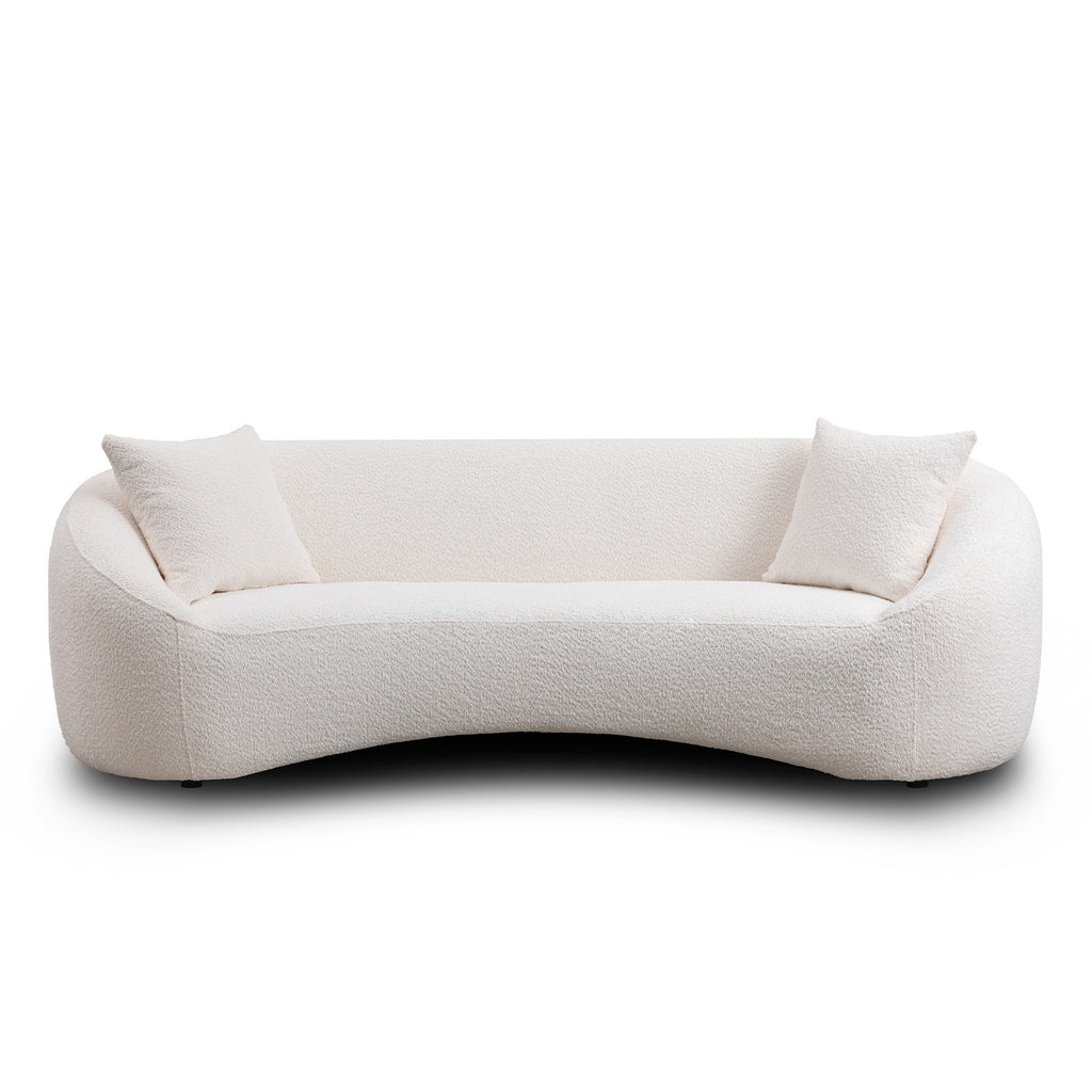Minimalist white curved sofa with plush seating and two cushions, ideal for modern living room interiors.