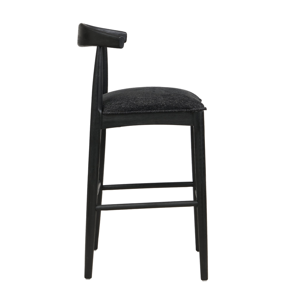 Side profile of black fabric bar stool with padded seat and angled backrest, highlighting ergonomic comfort and sleek silhouette.