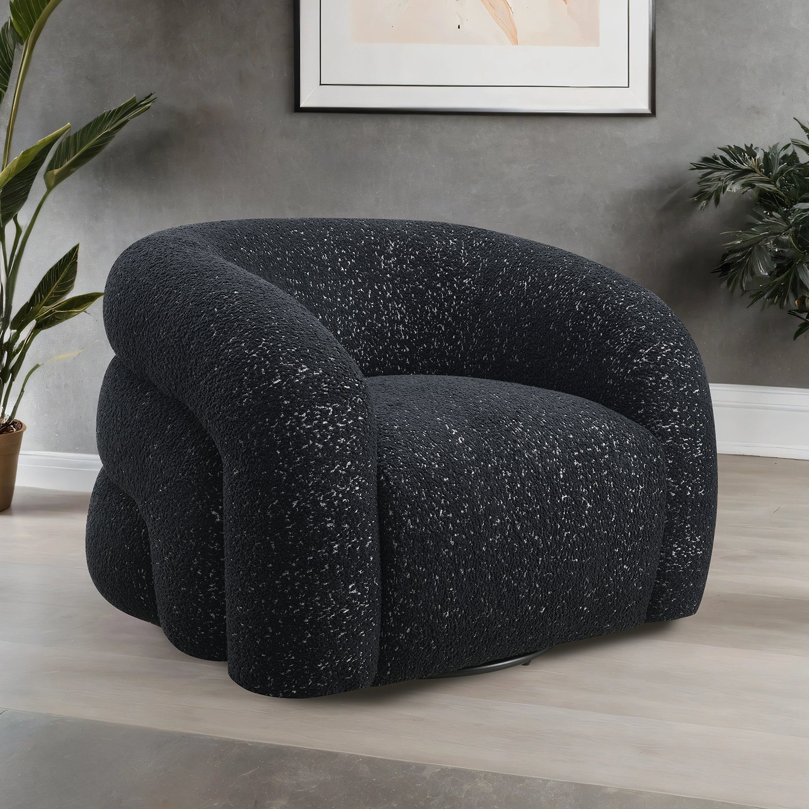 Contemporary black swivel chair with sculptural design and boucle texture, ideal for stylish interiors with 360-degree swivel functionality.