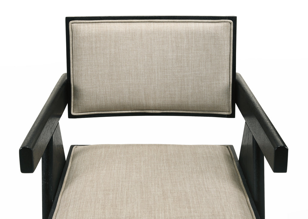 Close-up of Jasper dining chair seat and backrest in beige fabric. Black wood frame adds bold contrast and support.
