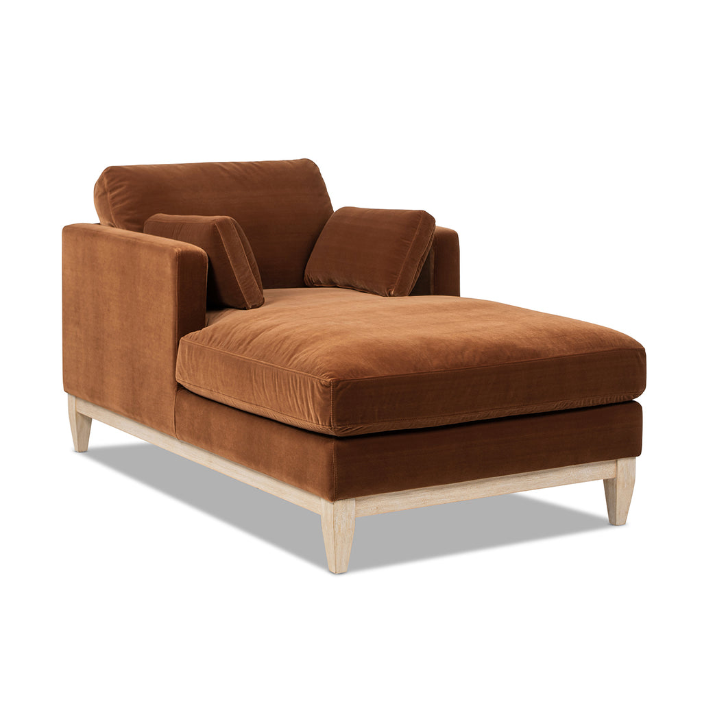 Side-angled view of Knox 65' Modern Farmhouse Chaise Lounge Chair in burnt orange velvet with light wood base and plush cushions.