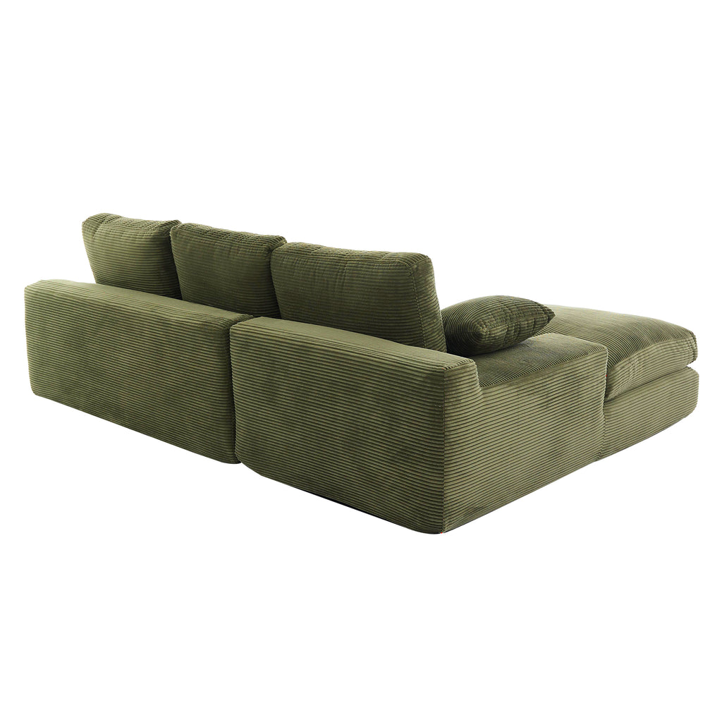 Angled rear view of green corduroy sofa with foam-filled cushions and pillows, designed for comfort and easy room placement.