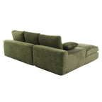 Angled rear view of green corduroy sofa with foam-filled cushions and pillows, designed for comfort and easy room placement.