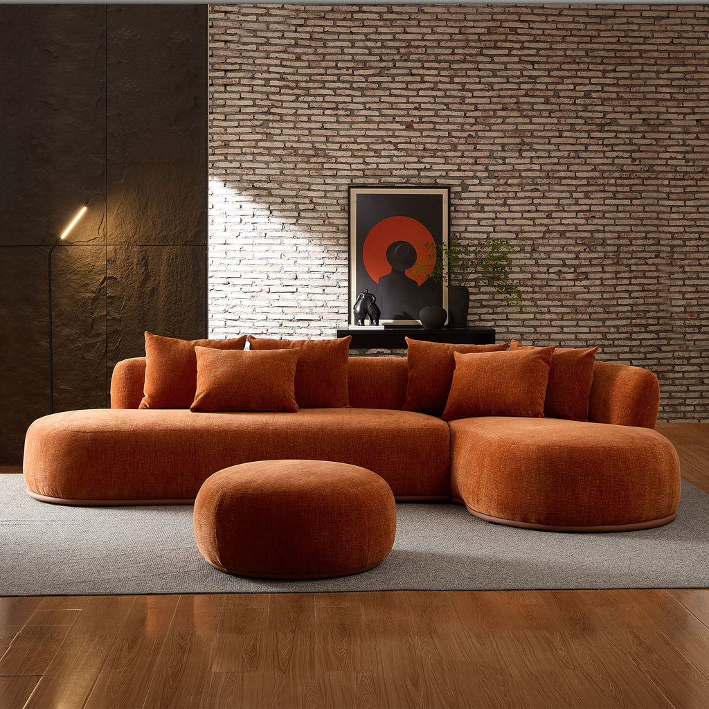 Contemporary oversized orange sectional sofa with ottoman in a loft-style room, perfect for large living spaces and modern decor.