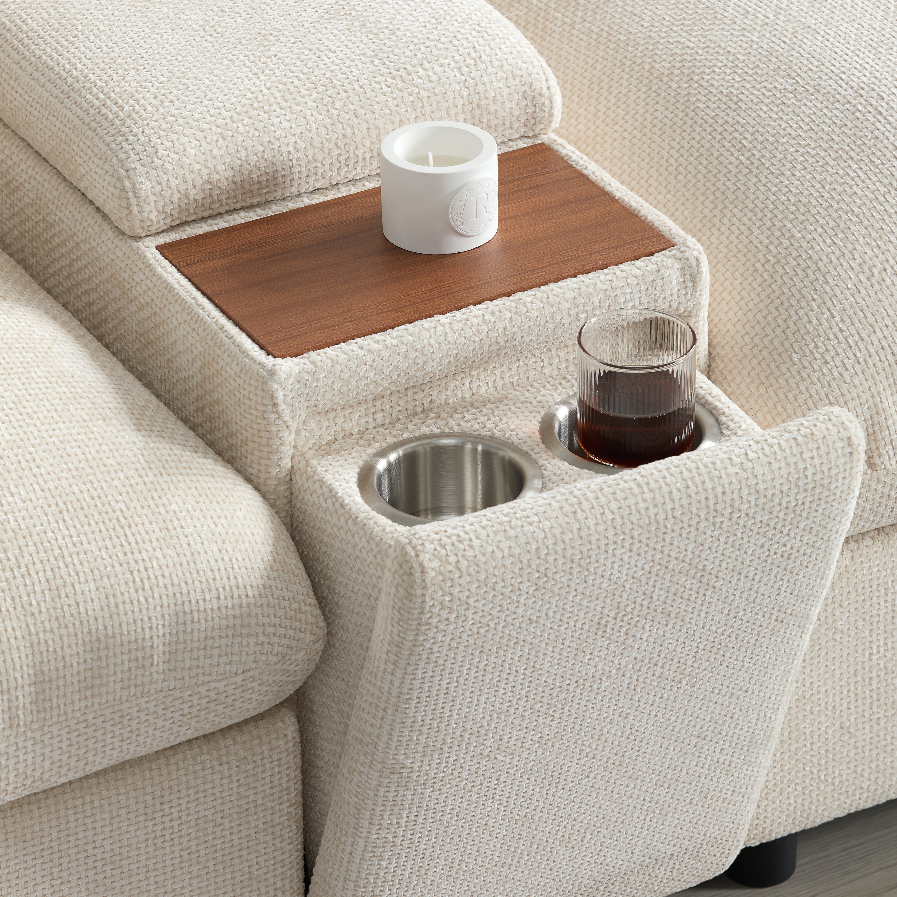 Detail of console on modular sectional sofa featuring cup holders and wooden tray. Enhances living room functionality and comfort.