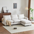 99 in. 4-piece L shaped modular sectional sofa with ottoman in white, set in a modern living room with wood flooring and neutral decor.