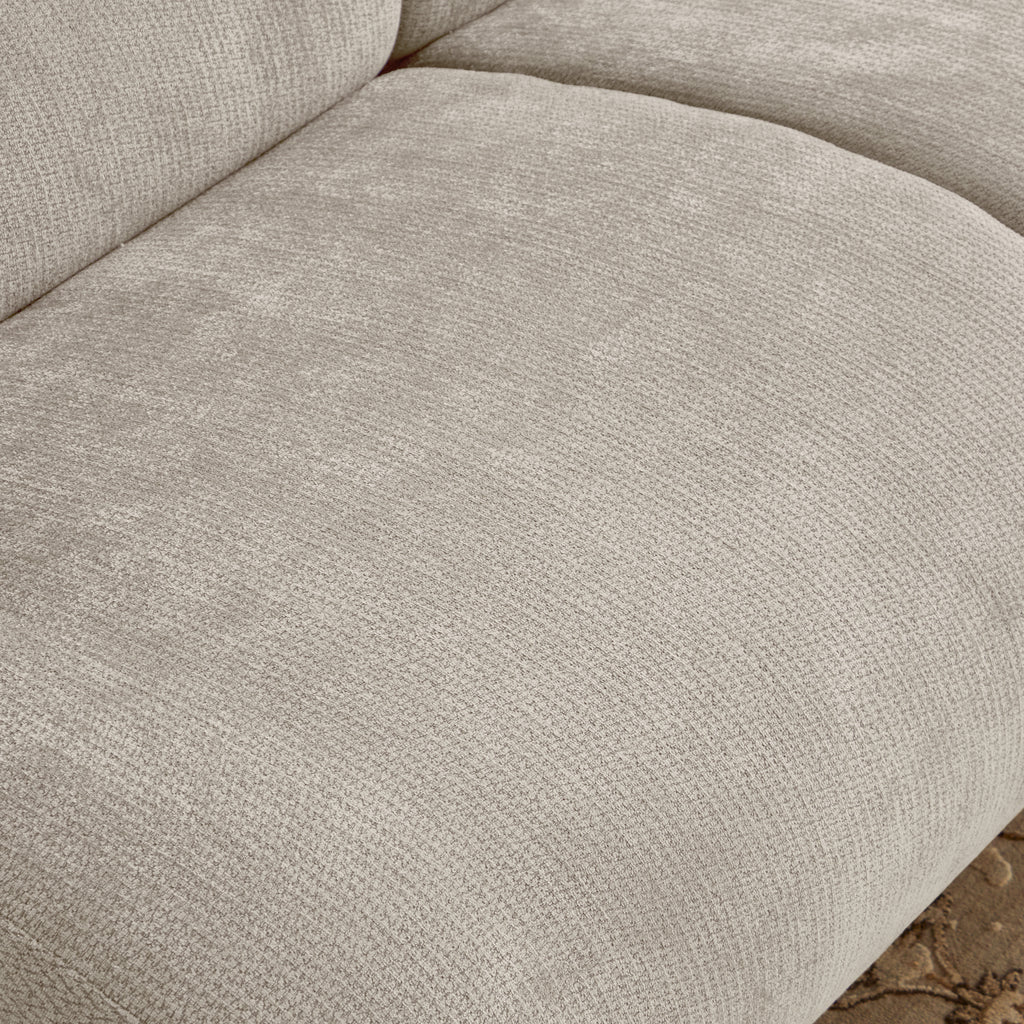 Close-up of chenille fabric texture on beige memory foam sofa seat, showcasing soft and durable material for everyday use.