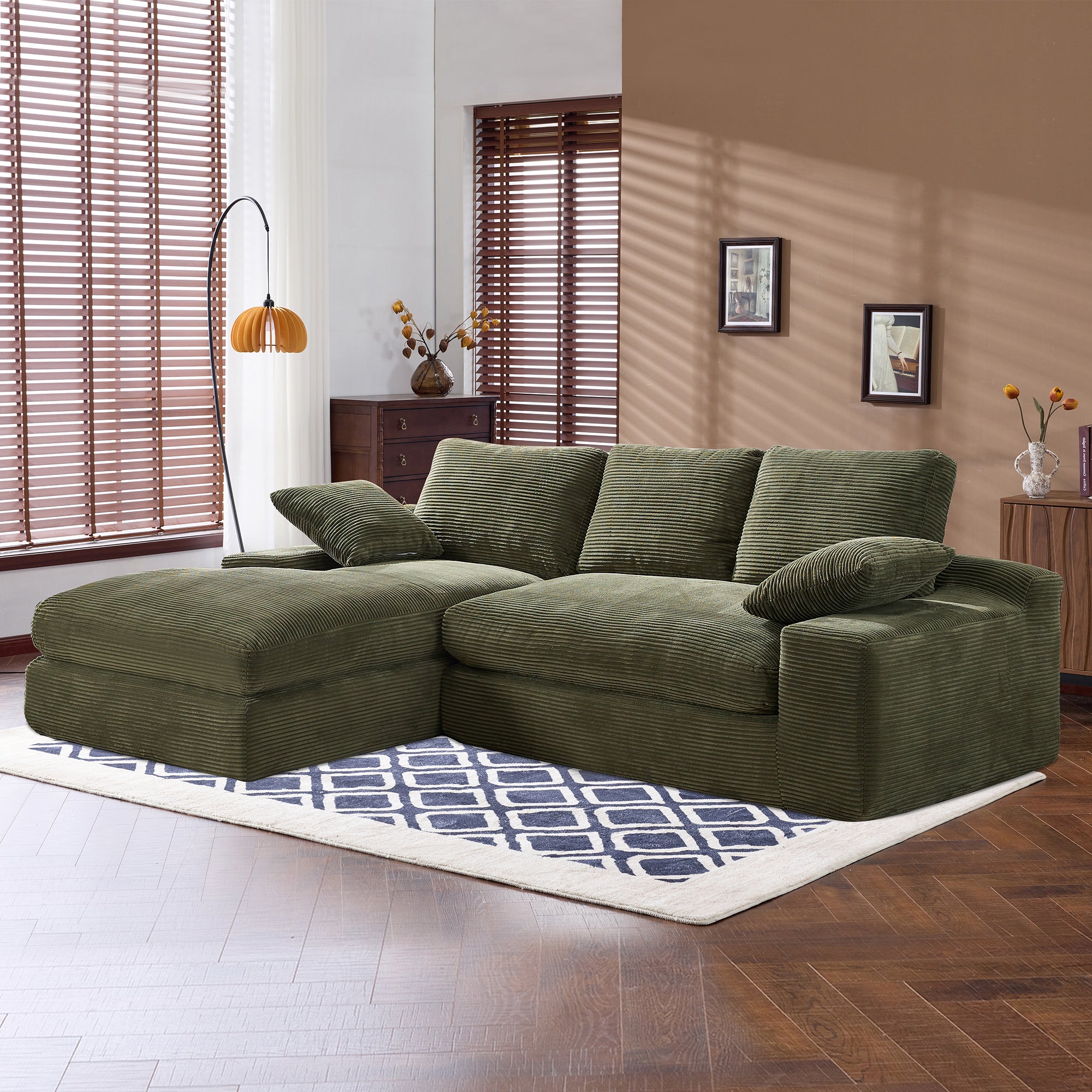 Green corduroy sofa with L-shape design and foam cushions in a sunlit room. Perfect for cozy, modern living spaces.