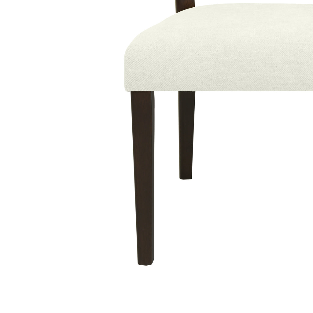 Close-up of Rattan Dining Chair leg and seat corner, highlighting the dark wood finish and soft cream upholstery texture.