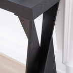 Detail of the crossed leg design on black console table, showcasing the sturdy and stylish construction.