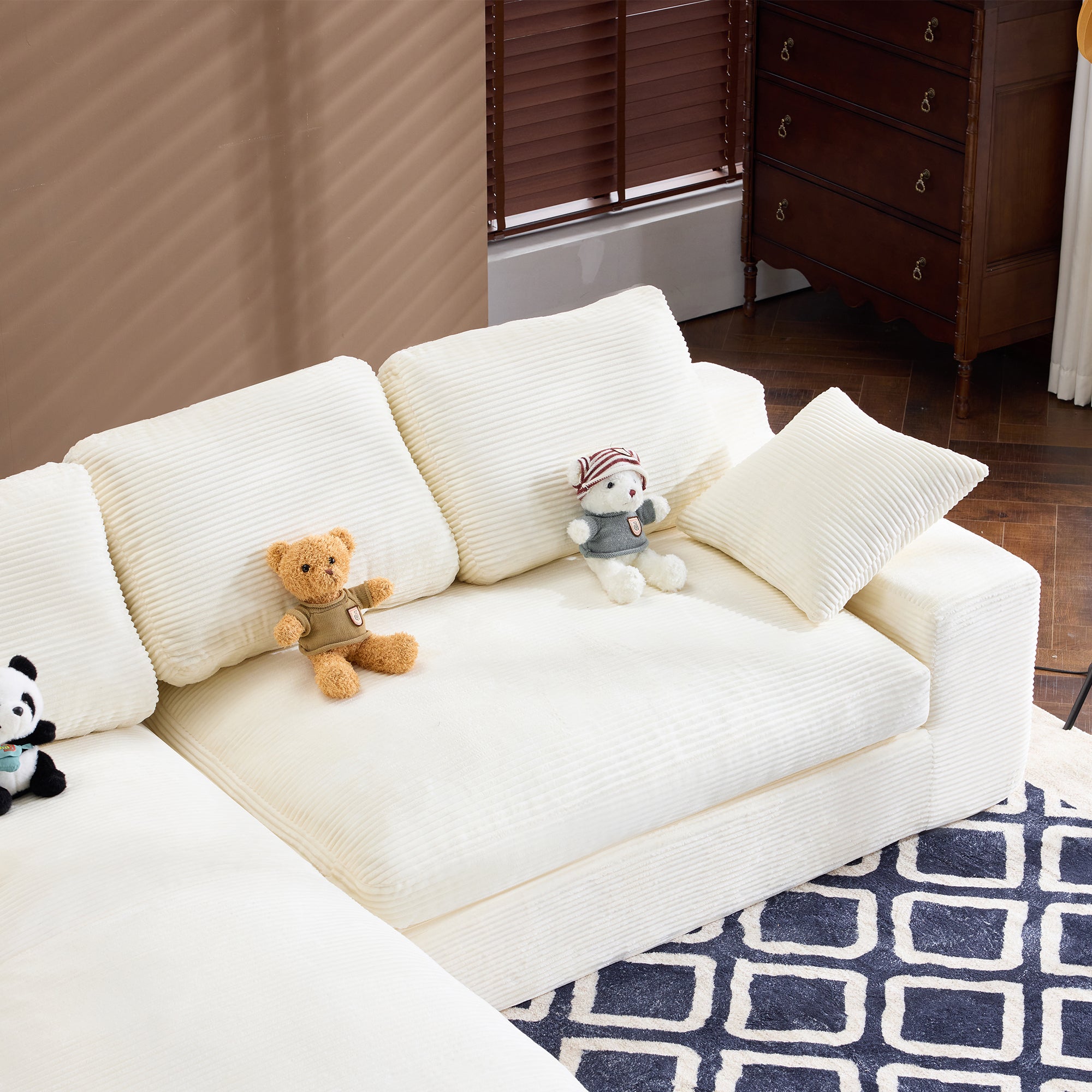 Overhead view of White Corduroy Sofa showing 4-seat layout with 3 back cushions and 2 pillows on a patterned rug.