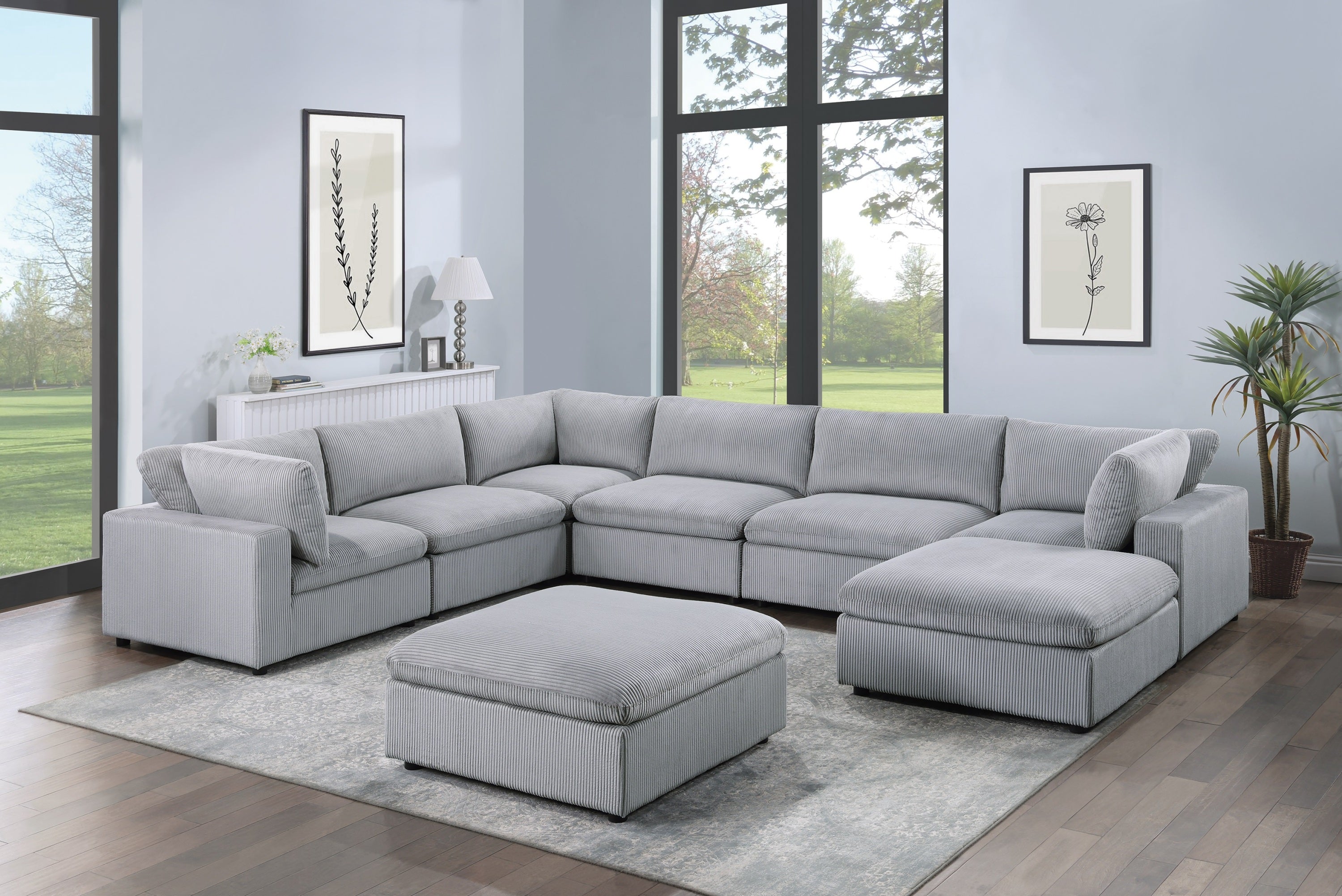 8-piece dark gray corduroy modular sectional with corner wedges, armless chairs, and matching ottomans in a living room.
