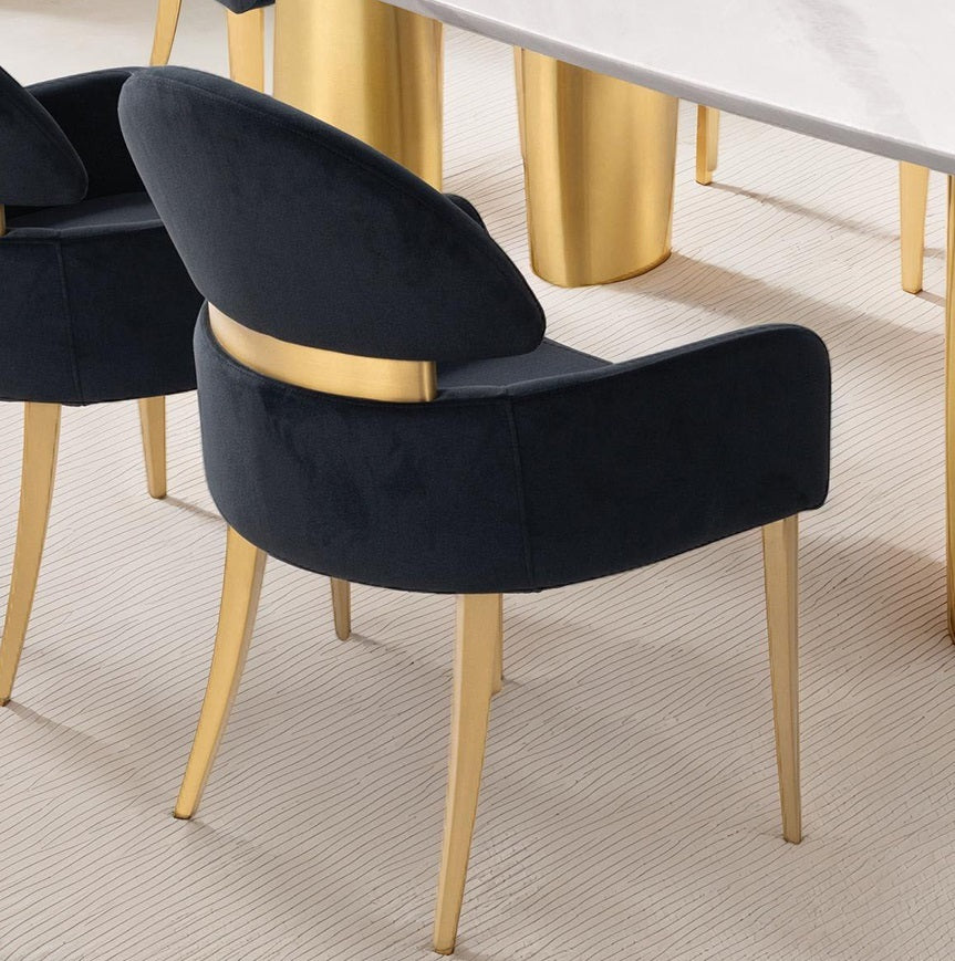 Back view of black dining arm chairs with curved design and matte gold legs, enhancing luxury dining room aesthetics.