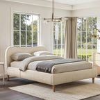Platform Bed - Beige Upholstered Curved Headboard placed in a sunlit room with large windows, showcasing its soft chenille fabric and wooden legs.