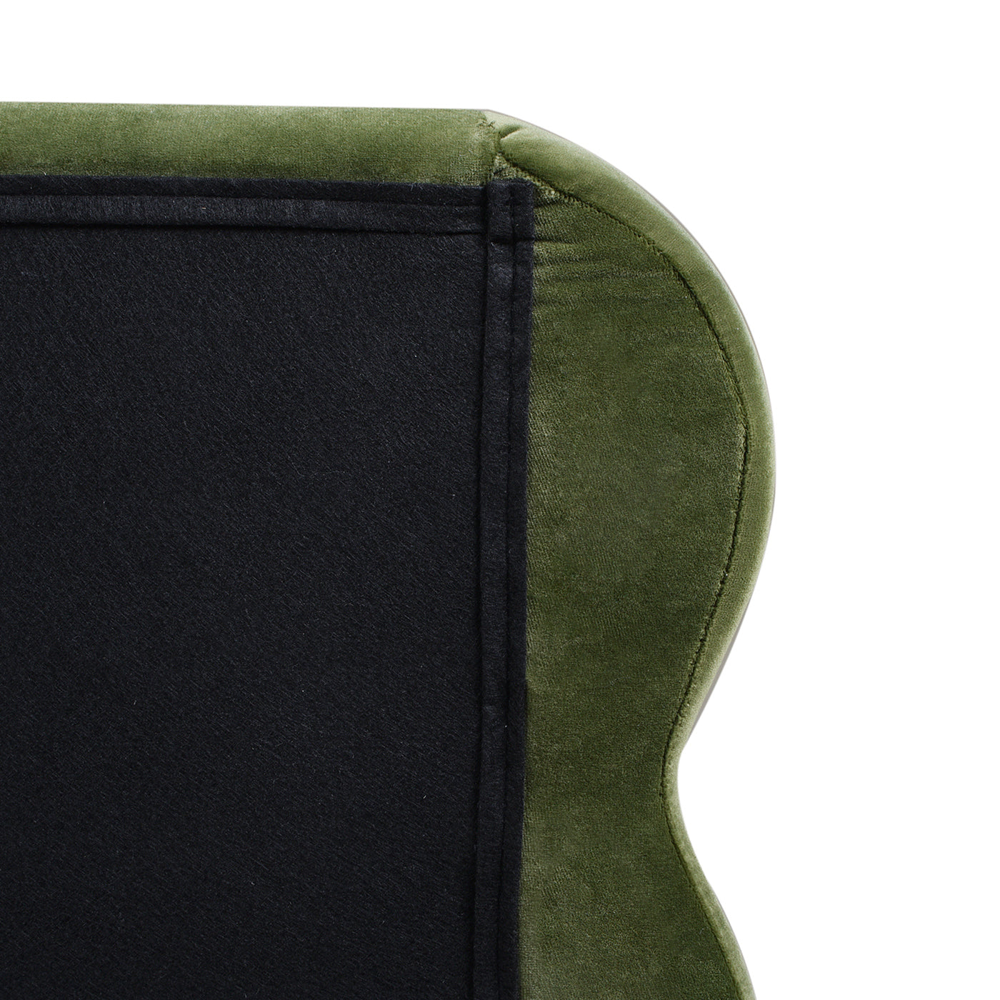 Backside close-up of the Stockholm Modern king bed's wavy headboard in olive green velvet with black fabric lining.
