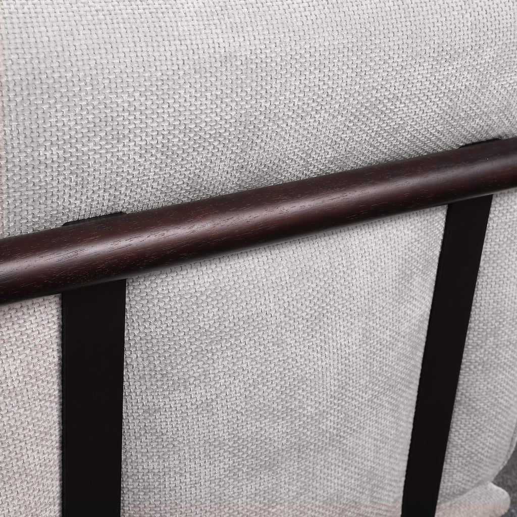 Close-up of textured light gray fabric and dark wood support bar on modular sectional sofa, emphasizing quality materials and craftsmanship.