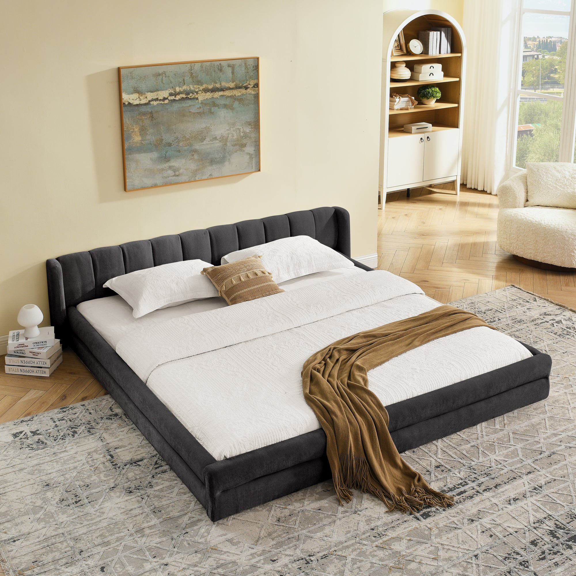 Modern dark gray chenille King Size Bed Frame with soft headboard and white bedding, placed on a patterned rug in a cozy room.