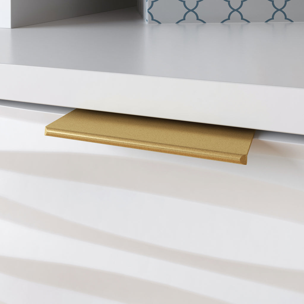Close-up of gold drawer pull on White Coastal Credenza, emphasizing the modern hardware and textured drawer design.