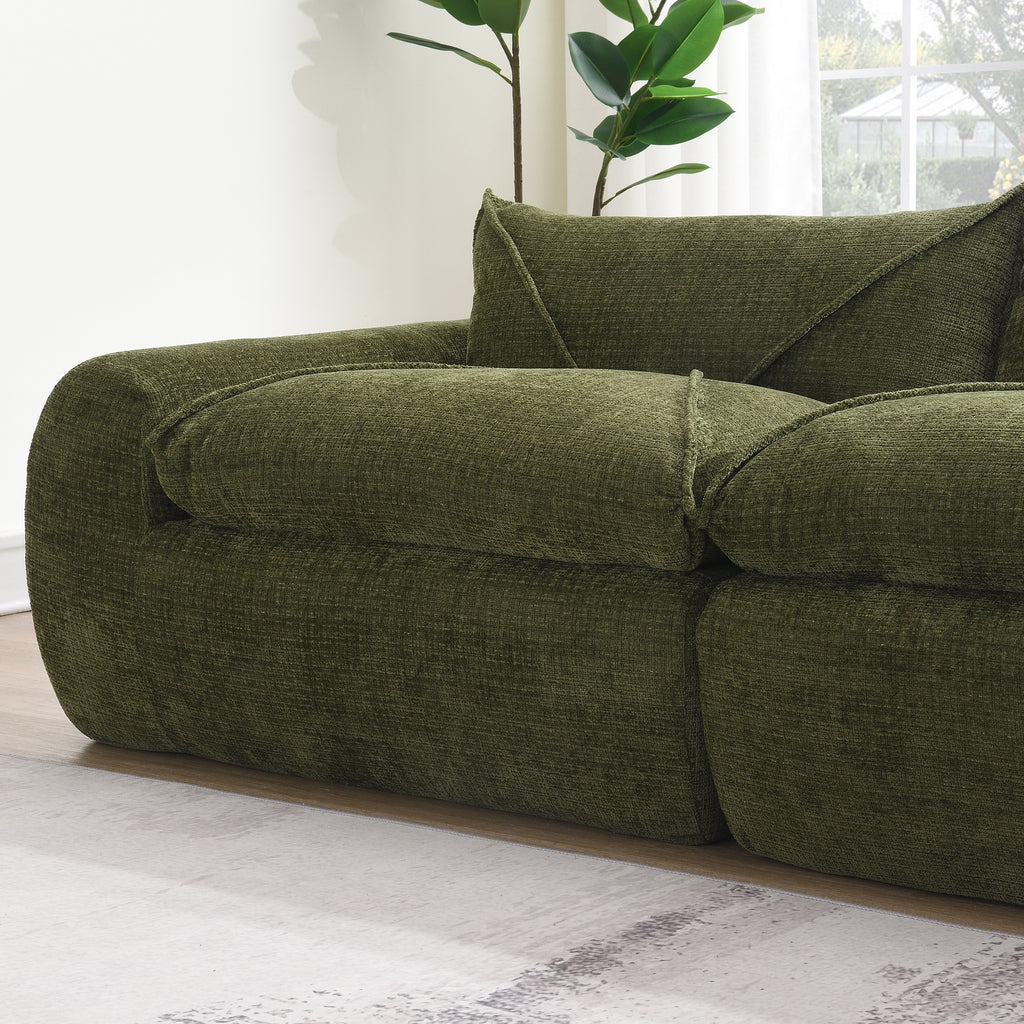 Close-up of armrest and cushion on 116'' compressed sofa, showing textured green fabric and high density foam comfort.