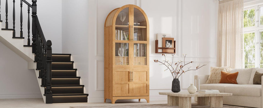 Tall arched kitchen pantry cabinet placed in a living space, blending storage functionality with stylish design and glass-front doors.