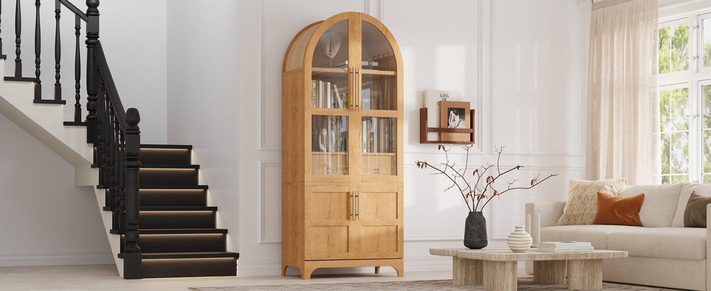 Tall arched kitchen pantry cabinet placed in a living space, blending storage functionality with stylish design and glass-front doors.