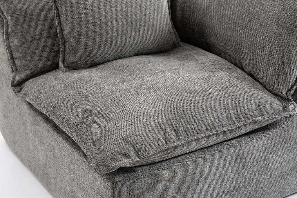 Close-up of the Cloud Couch seat cushion showing soft, textured antique grey velvet upholstery and plush foam padding.
