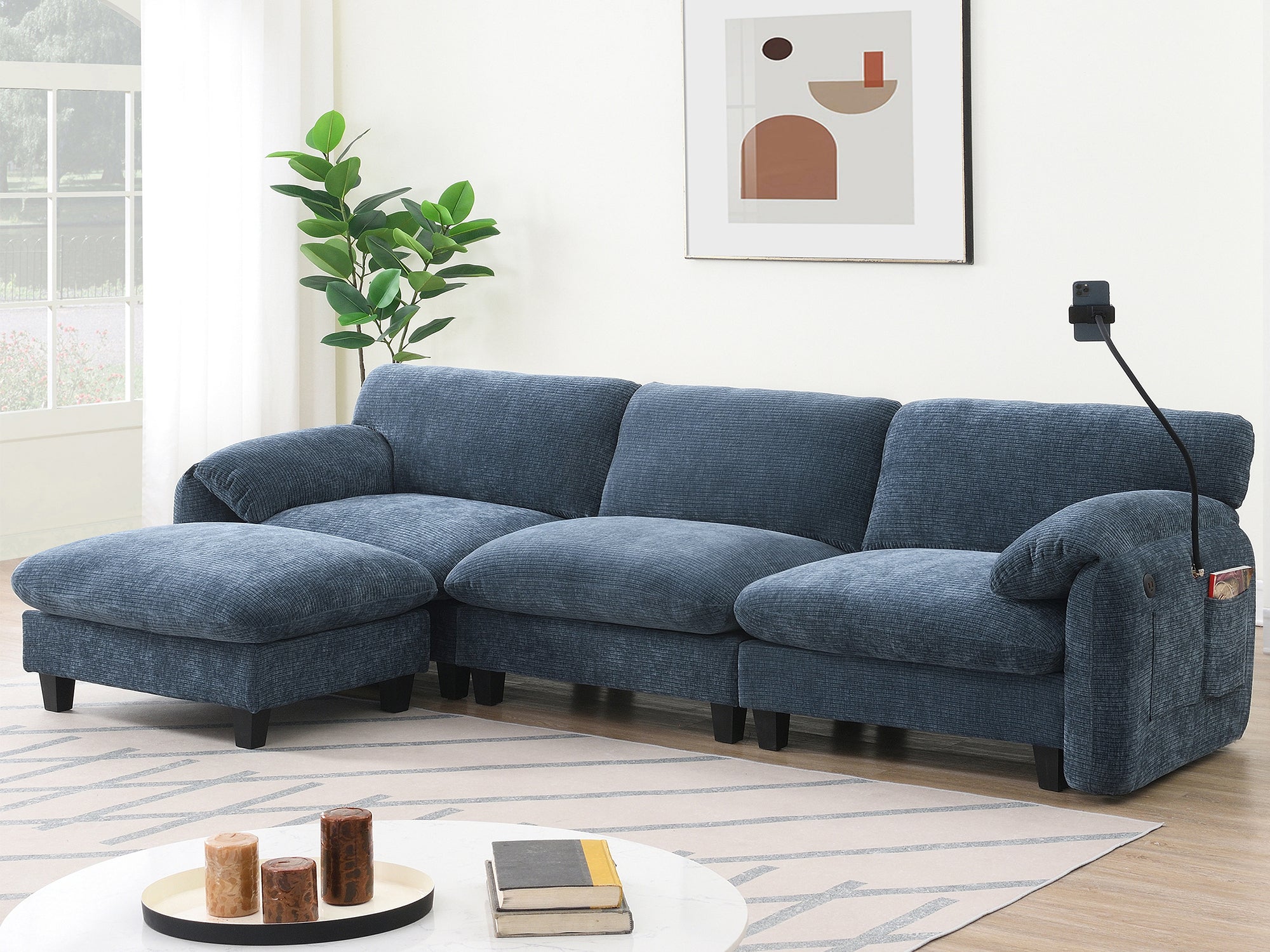 Blue modular sectional sofa with USB charger and ottoman in modern living room. Includes phone holder and side pocket for added functionality.
