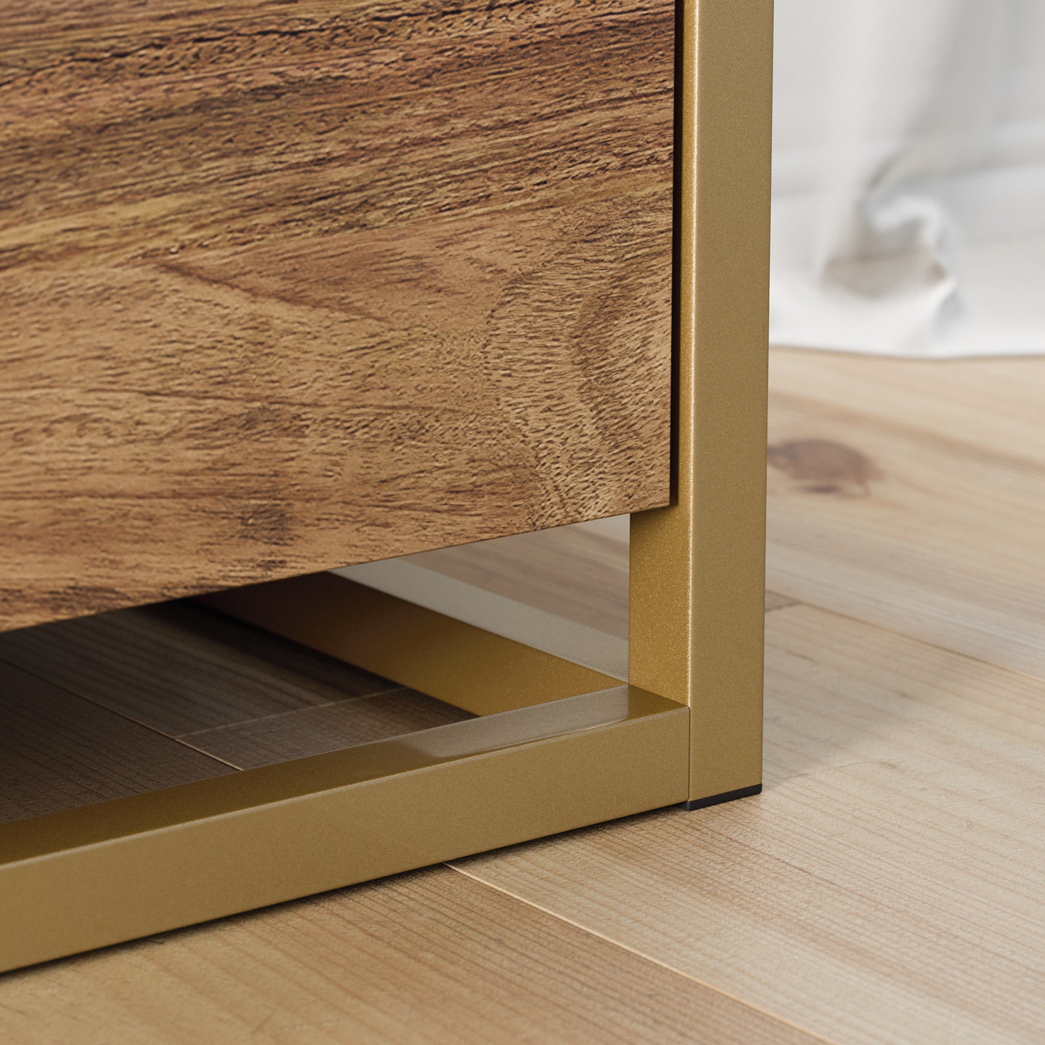 Close-up of gold metal frame base on brown lateral file cabinet, highlighting sturdy construction and modern design.