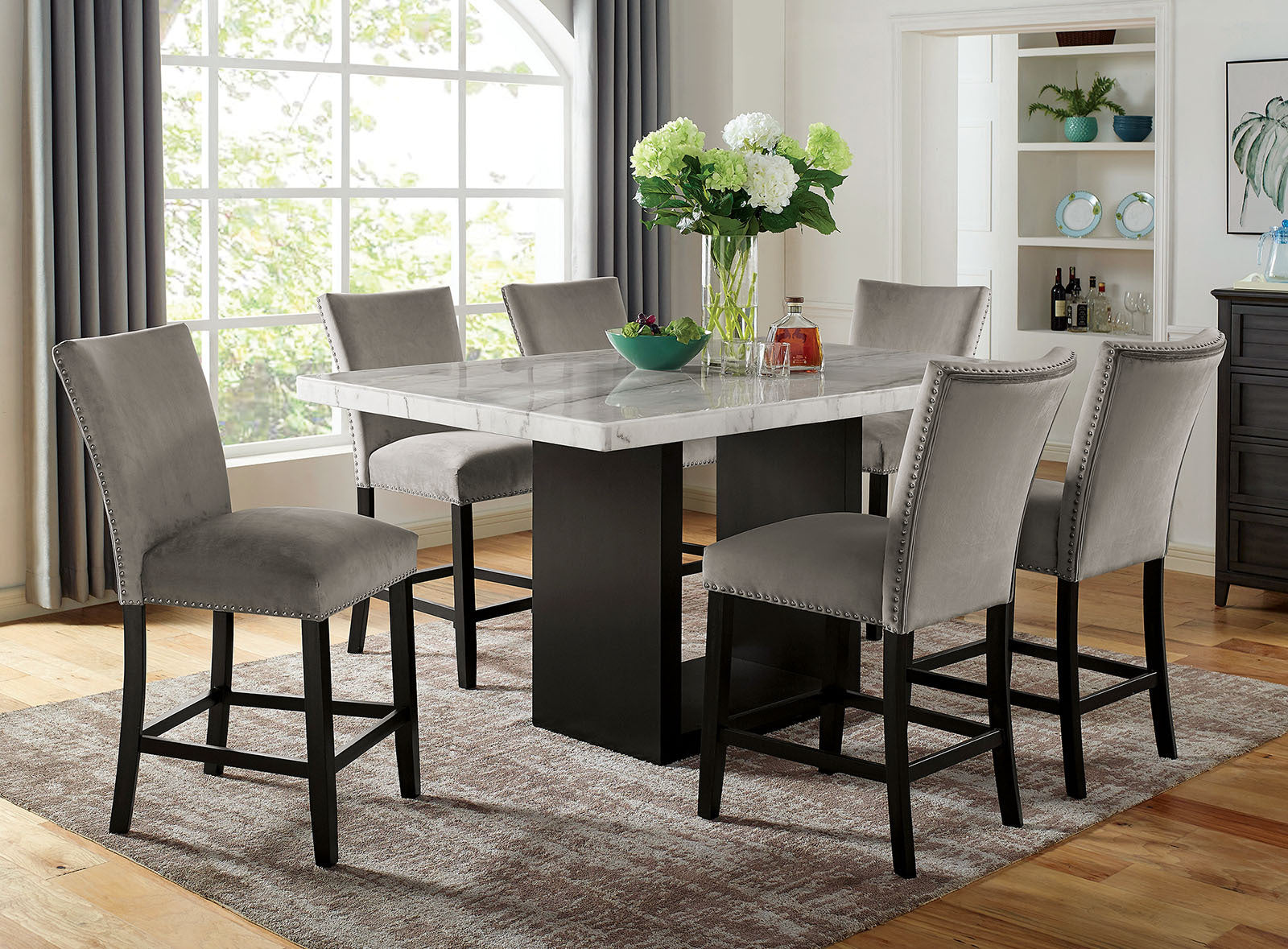 Full dining room setup featuring genuine marble dining table with solid wood base and six upholstered counter height chairs.