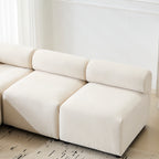 Close-up of the Evelyn sectional sofa's chenille fabric and armless middle seat, showcasing soft texture and modular design.