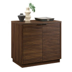 Angled view of Library Base, Brown finish cabinet with decorative items on top, ideal for modern office or home use.