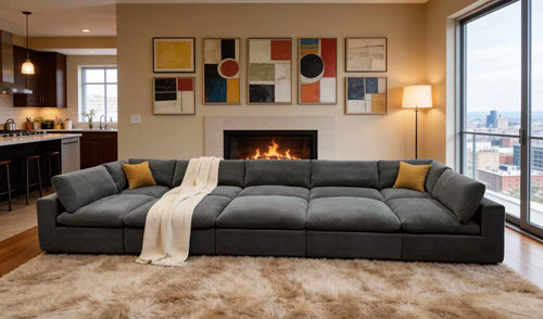 Dark gray modular sectional sofa with coffee-bean texture, featuring yellow toss pillows and a cozy cream throw blanket.