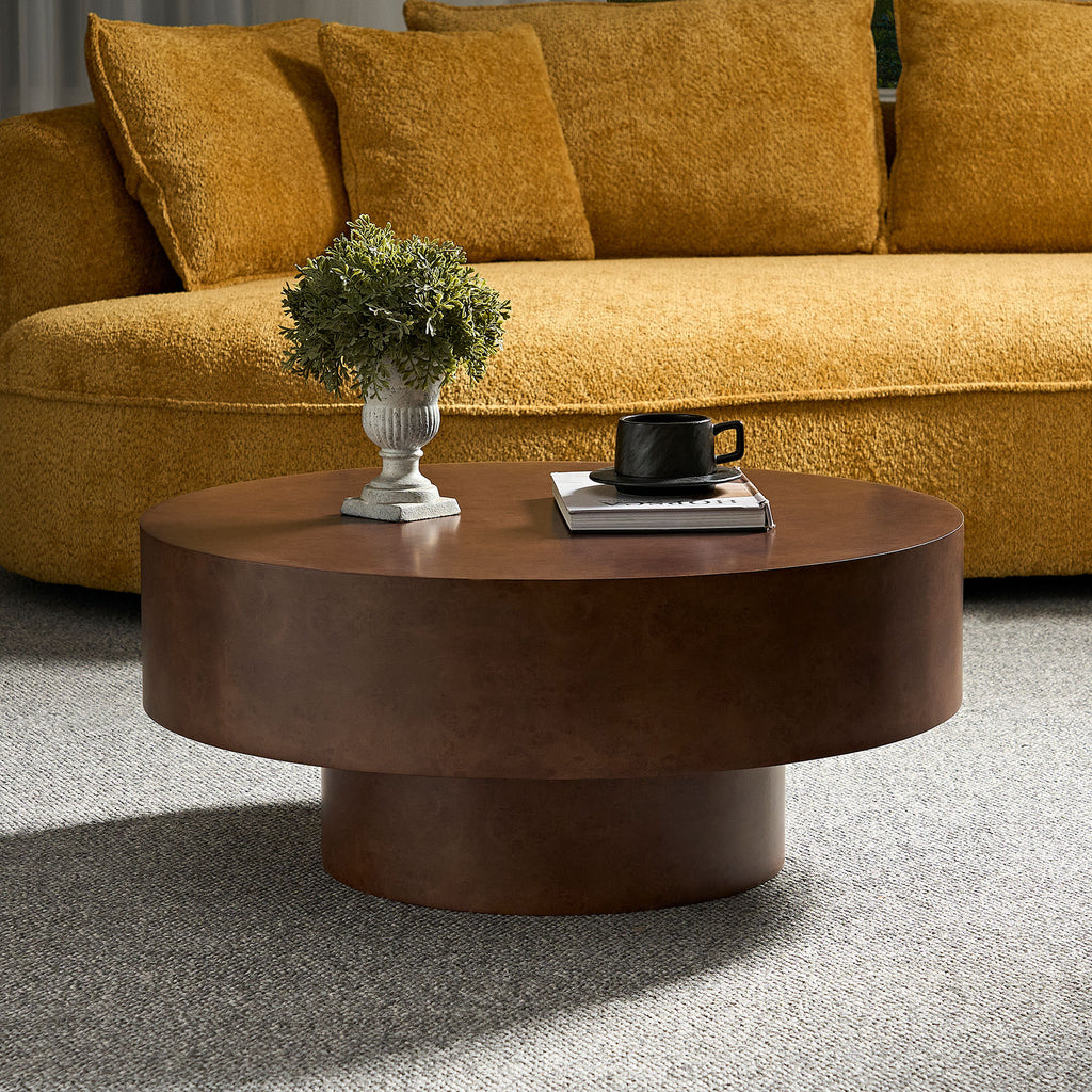 Round Faux Burl Coffee Table with sturdy pedestal base, styled in a cozy living room with mustard sofa and neutral rug.
