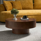 Round Faux Burl Coffee Table with sturdy pedestal base, styled in a cozy living room with mustard sofa and neutral rug.