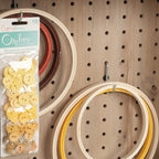 Pegboard in Craft Cart with Storage for Home holding embroidery hoops and buttons, ideal for craft supply organization.