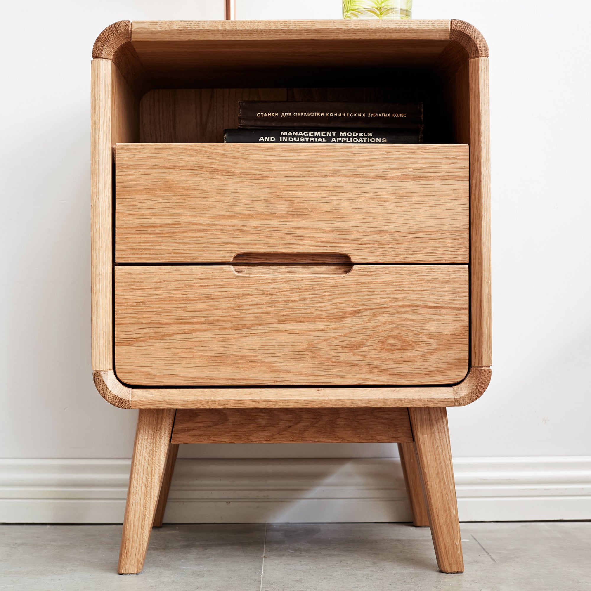 Solid Wood Bedside Cabinet - Organized Storage featuring books in open shelf and sleek drawer design for modern interiors.
