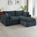 Oversized, dark gray corduroy modular sectional sofa with deep, plush cushions in a modern living room setting.