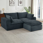 Oversized, dark gray corduroy modular sectional sofa with deep, plush cushions in a modern living room setting.
