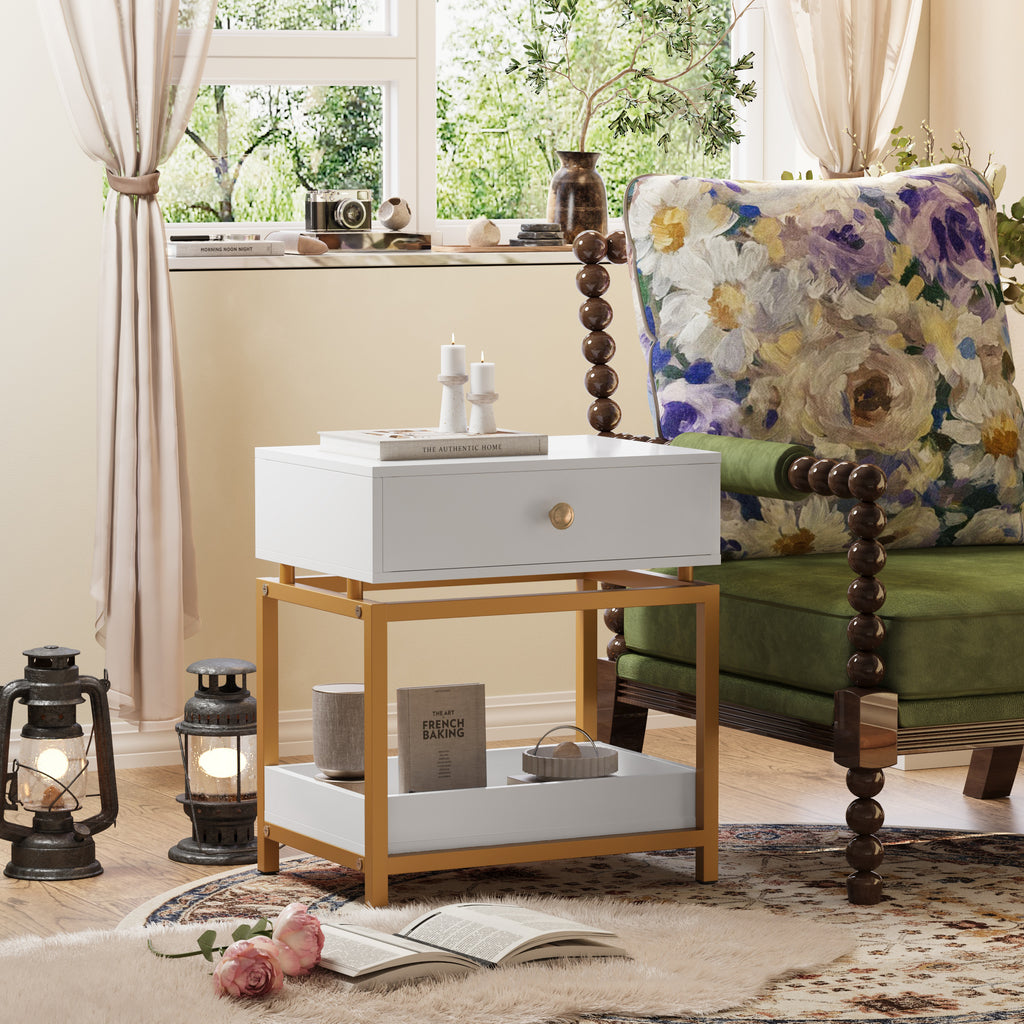 Modern white end table with a gold metal frame, featuring a single storage drawer and an open bottom display shelf.