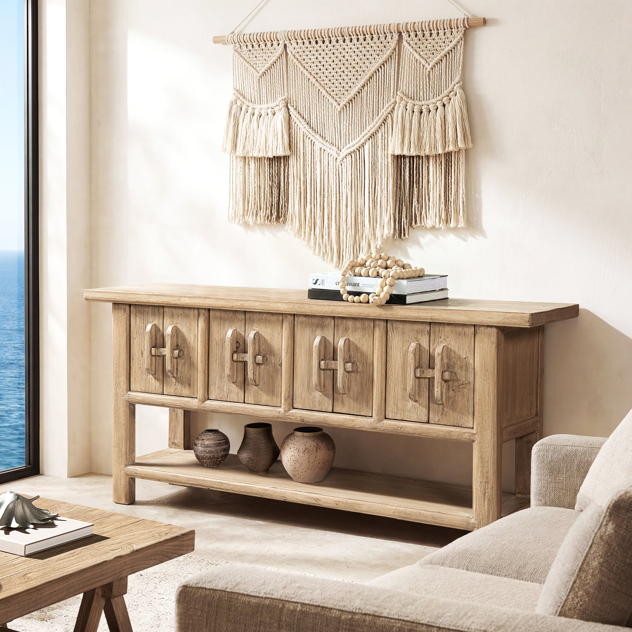 60-inch solid reclaimed pine sideboard in light natural brown with four cabinet doors, unique handles, and lower shelf.