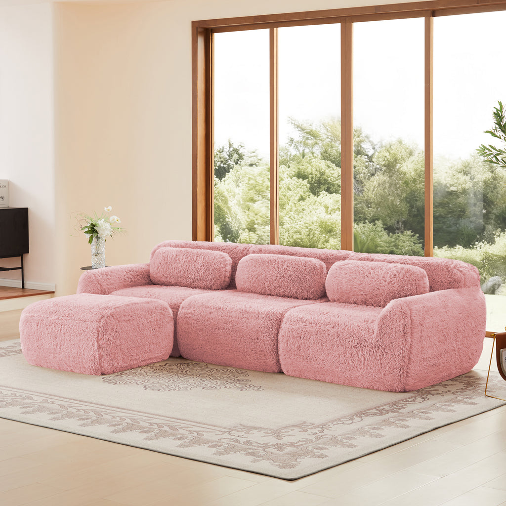 Angled view of plush modular sofa in pink with movable ottoman. Ergonomic and anti-slip, ideal for cozy and stylish living room setups.