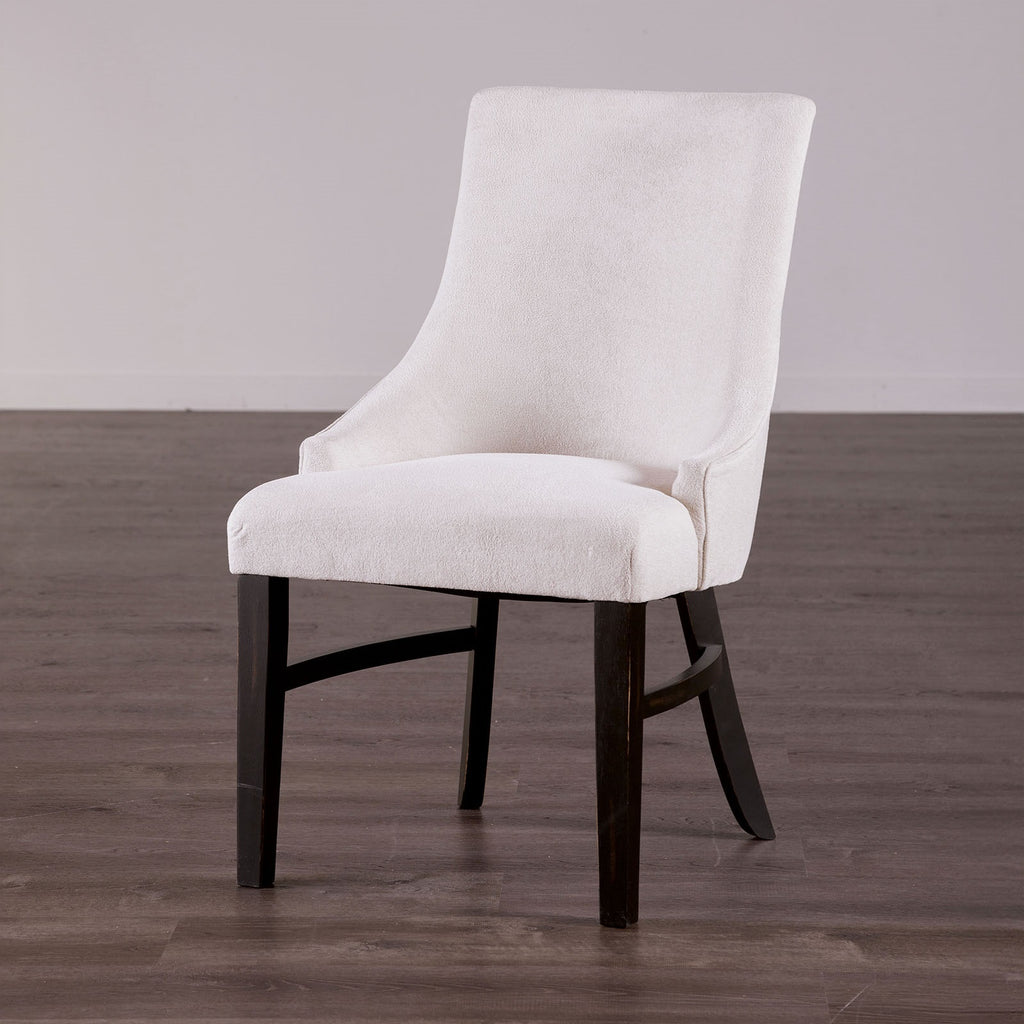 Stylish padded wingback dining chair in beige with black legs, perfect for transitional dining room furniture collections.