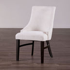 Stylish padded wingback dining chair in beige with black legs, perfect for transitional dining room furniture collections.