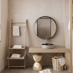 Round Black Metal Medicine Cabinet with Mirror in a natural-toned bathroom with wood and wicker decor elements.