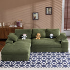Green corduroy sofa with cushions and pillows on geometric rug, ideal for cozy living rooms. Soft foam filler and plush texture enhance comfort.