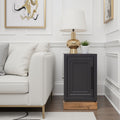 Nora Chairside Table - Black Whiskey Finish beside a white sofa with gold lamp and wall art, ideal for modern living rooms.