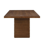 Side profile of Coad 84-inch Walnut Dining Table highlighting thick tabletop and vertical slatted pedestal base in rich walnut finish.