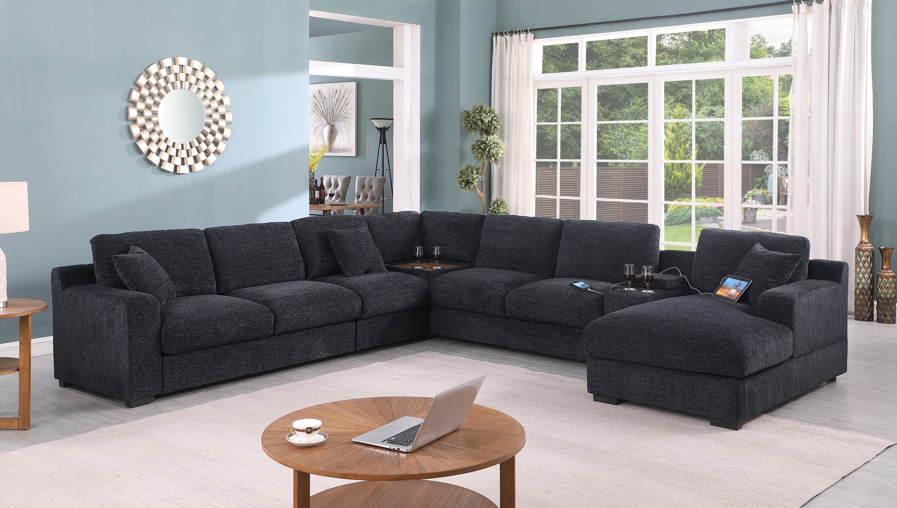 Dark gray Celine sectional sofa with chaise in a bright living room. Includes cupholders, USB ports, and removable cushions.